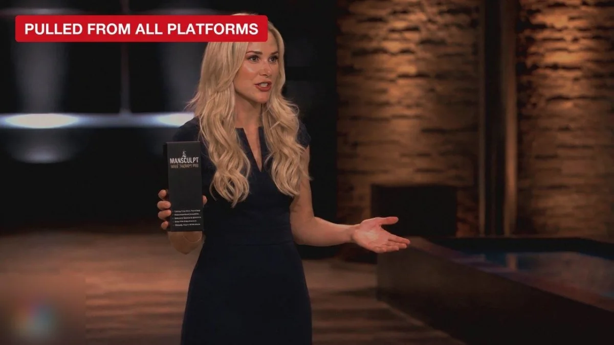 Dr Julia Caldwell on the Shark Tank stage, holding the ManSculpt
